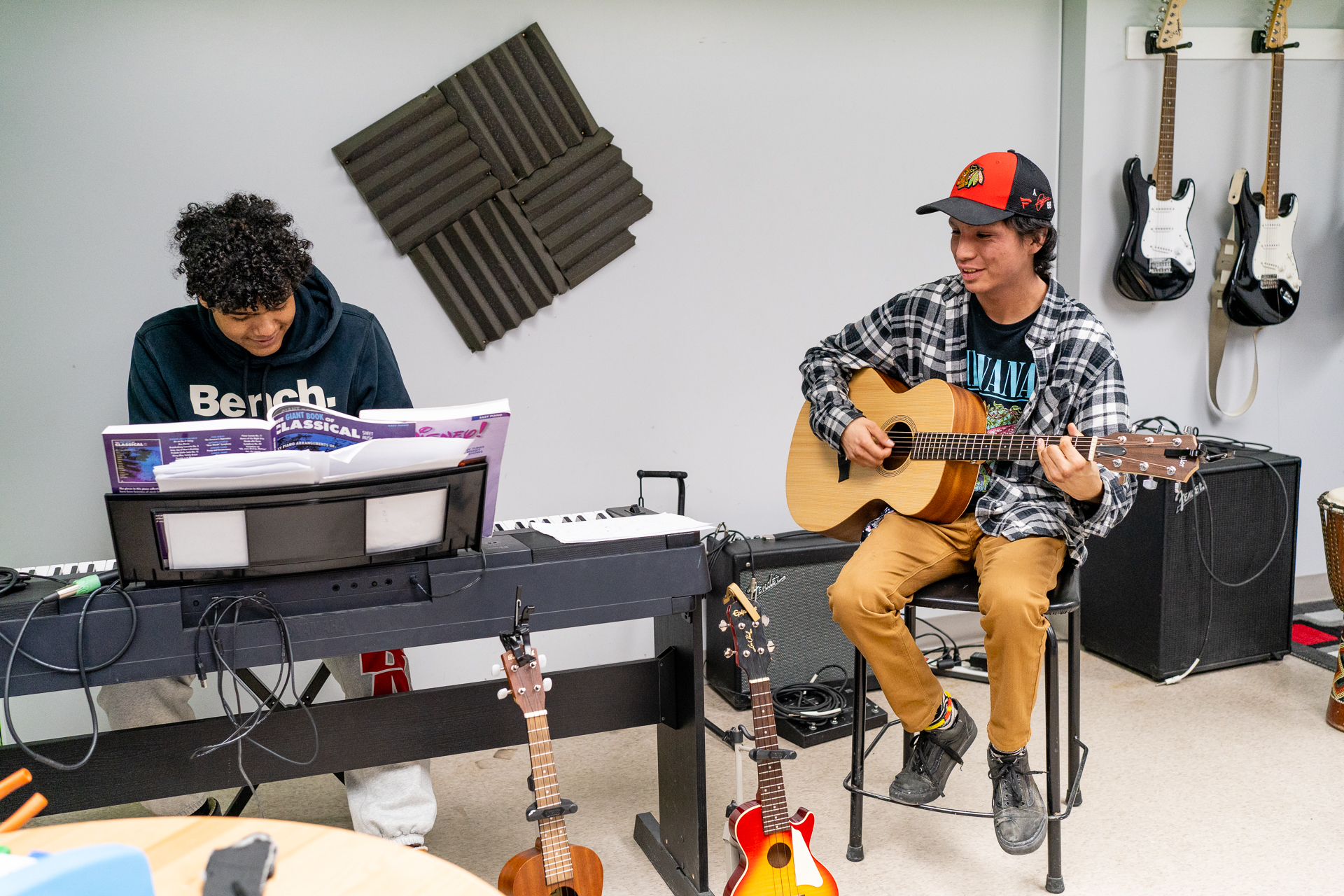 18-year-old Evan and Gabe jamming on the guitar and piano at the music studio at Teen Stop Jeunesse, a donor-supported agency
